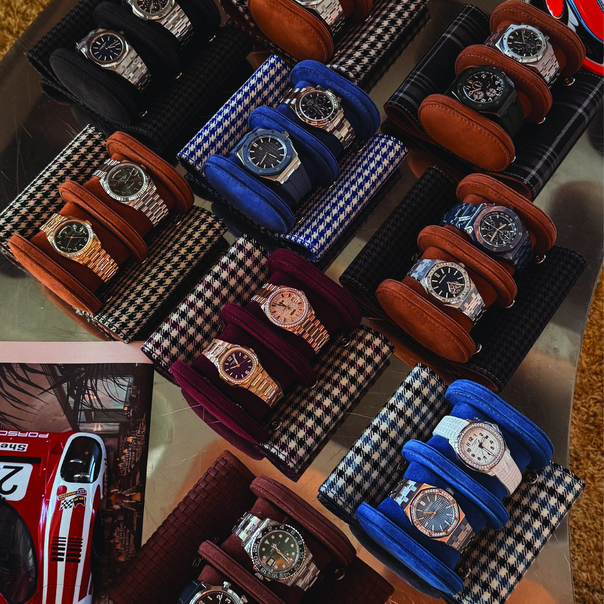 Elemento travel watch rolls in houndstooth, herringbone and leather, laid out with watches in each cradle