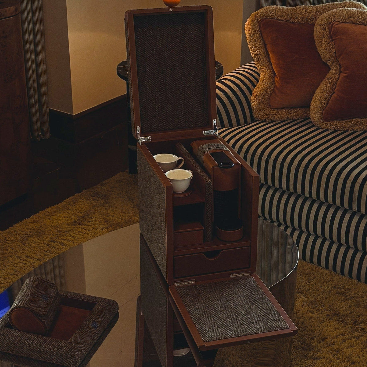An Elemento mahogany coffee chest standing open in a panelled sitting room, cups and capsule drawer out